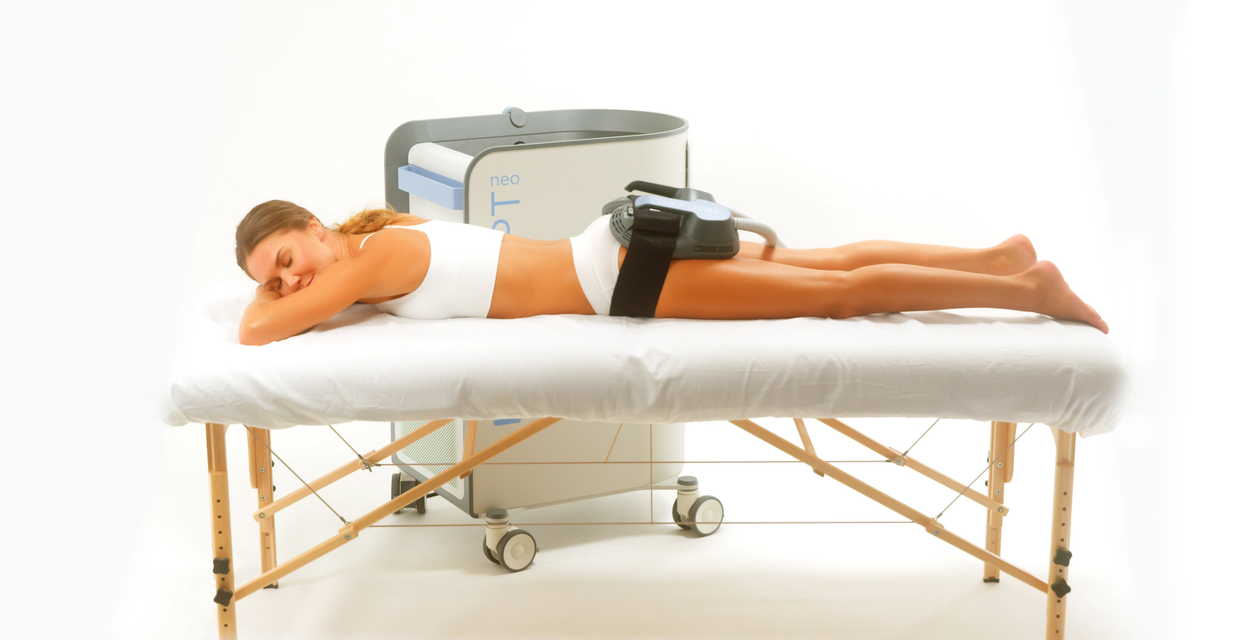 Photo of a woman getting Emsculpt treatments on her buttocks