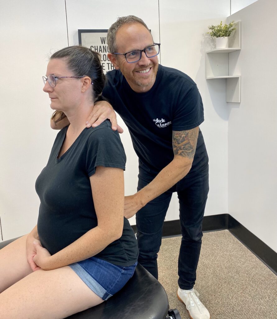 Photo of Dr. Chad providing prenatal chiropractic services to a patient