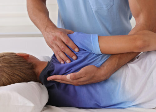 Photo of a chiropractor working on a child patient